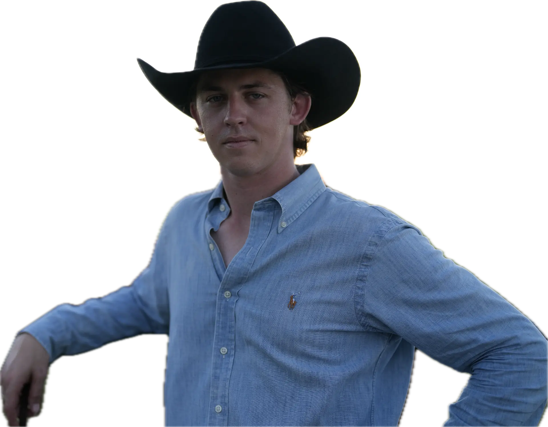 Trevor Hedeman, CALCAR founder and CEO — portrait in a black felt cowboy hat and light chambray shirt, one hand resting on a fence rail